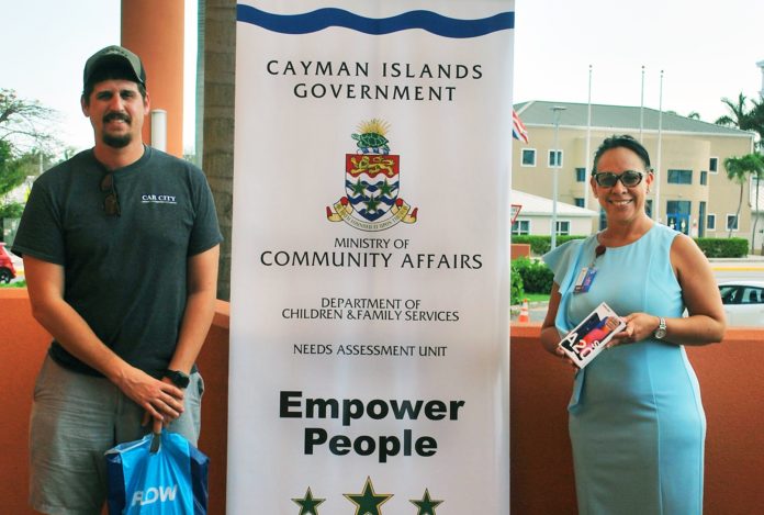Car City manager Taylor Foster delivers the phones to Ministry of Community Affairs Chief Officer Teresa Echenique