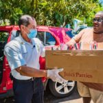 Community steps up to help stranded Nicaraguan passengers Volunteer Marlon Thomas Hodgson, left, delivers food from Island Taste to a stranded passenger.