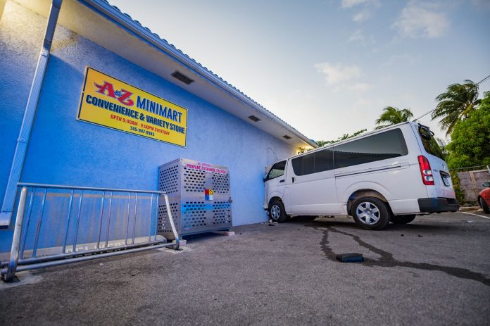 white bus crashed into the wall of the A-Z Minimart on Godfrey Nixon Way following a police chase on Monday afternoon