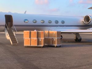 Boxes of the test kits arrive on a private plane at the Owen Roberts International Airport on Wednesday morning.