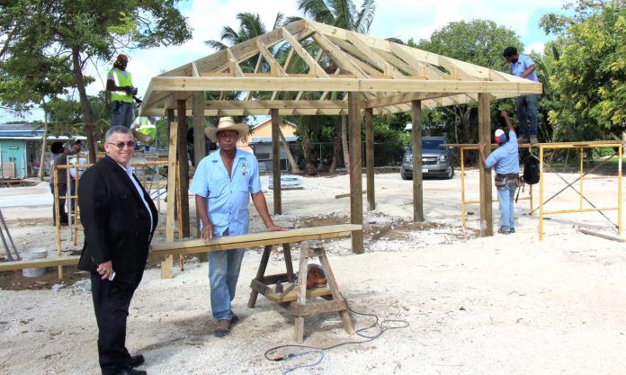 McKeeva Bush looks on as Public Works Department staff work on the new playground in December 2018