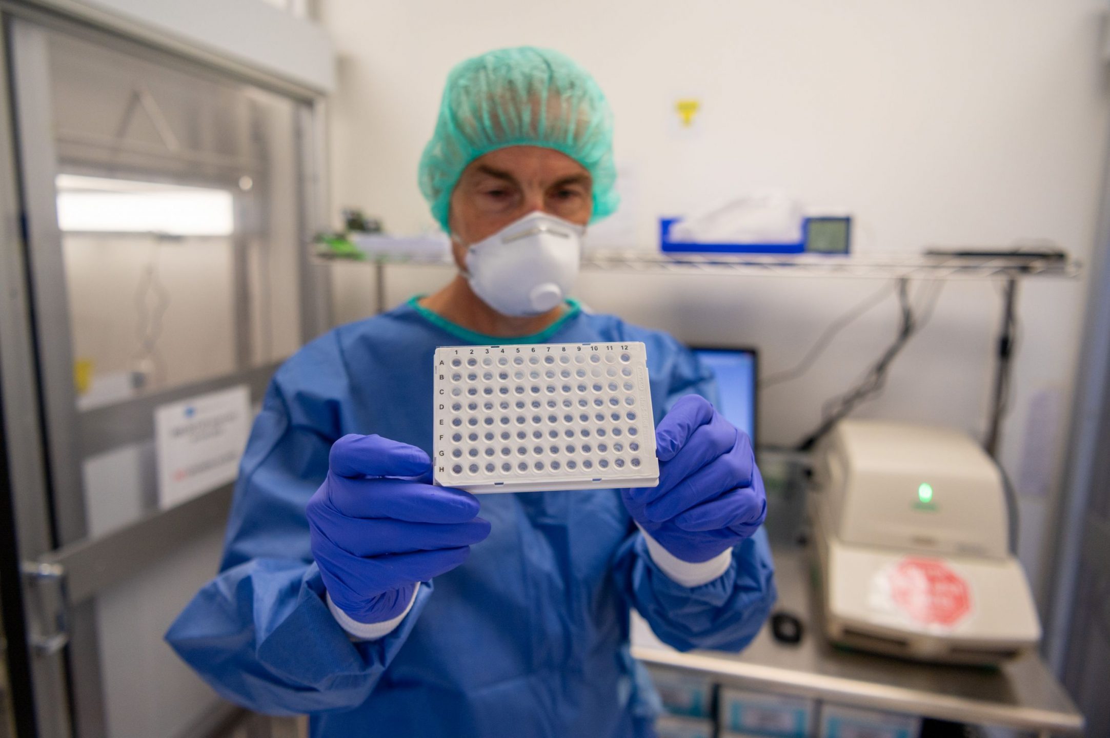 Dr. Frank Koentgen displays the flight of vials which gets loaded with samples to be tested in the PCR machine.