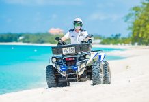 Government considers easing beach ban and Sunday lockdown An officer on ATV beach patrol.