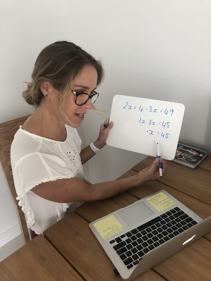 CIS middle school teacher Lee-Anne Corin gives a remote lesson from her home