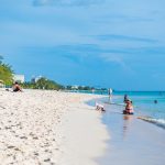 Ask the experts – The future of tourism Families enjoy the serenity of Seven Mile Beach on a recent afternoon. Photo: Taneos Ramsay