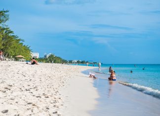 Ask the experts – The future of tourism Families enjoy the serenity of Seven Mile Beach on a recent afternoon. Photo: Taneos Ramsay