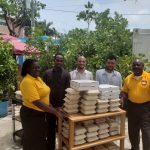 Alumni group distributes food packets