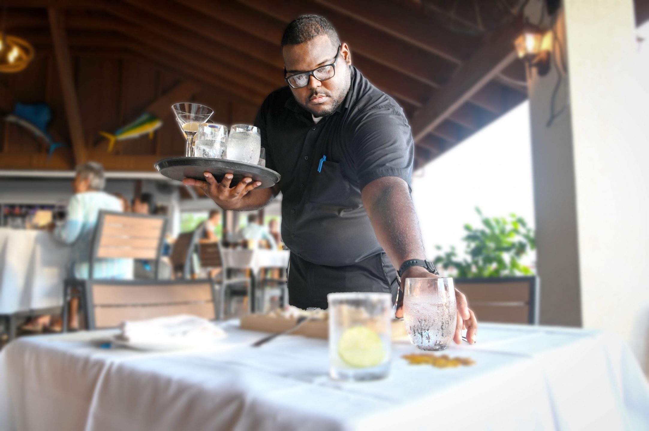 Restaurants and hotels have made efforts to train Caymanians but the sector is dominated by expats. Caymanian Ahmed Myles is pictured during a training programme at Grand Old House. - Photo: Alvaro Serey