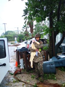 Cayman Islands Regiment commander comforts baby after Tropical Storm Grace