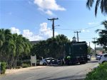Three taken to hospital after car and garbage truck collide