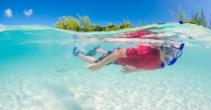 Boy-snorkeling-in-clear-water-in-the-Cayman-Islands