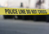 Ignited military grade flare washed ashore in a barrel on Bodden Town beach Yellow police line tape
