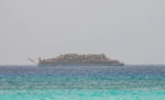 Tug boat repair pauses scrap metal barge departure