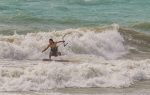 Surfers brave waves left by Ian