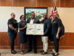 Stamp issue celebrating late centenarian presented to his children
