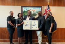 Stamp issue celebrating late centenarian presented to his children