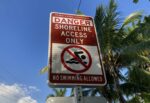 ‘No swimming allowed’ signs at beach access paths raises questions