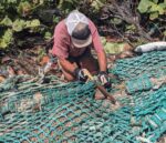 Couple removes giant fishing net from Little Cayman beach