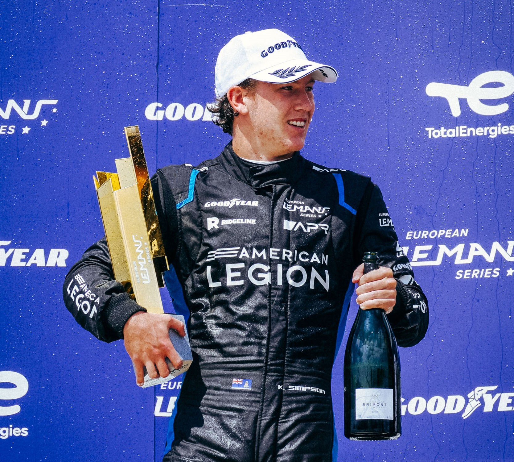 Kyffin Simpson with trophy and bottle Cayman Compass