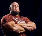 Cayman flexes muscles for Strongman event