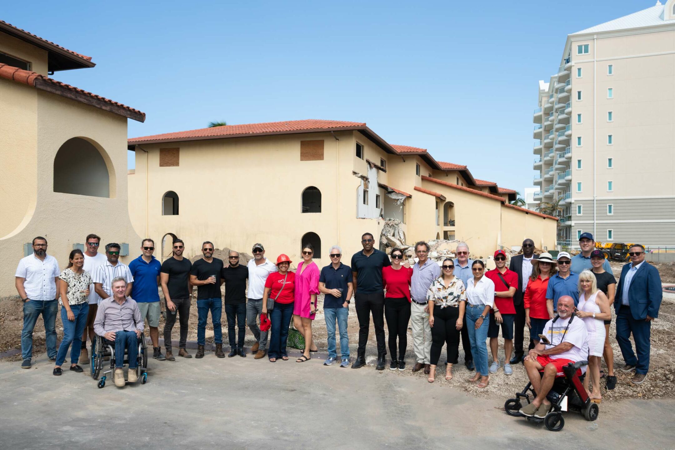Owners, stakeholders, and real estate agents gather to watch the demolition of Lacovia on Friday.