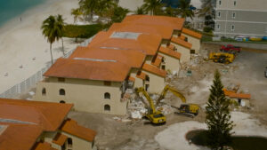 Excavators start demolition of the tiring Lacovia condominiums.