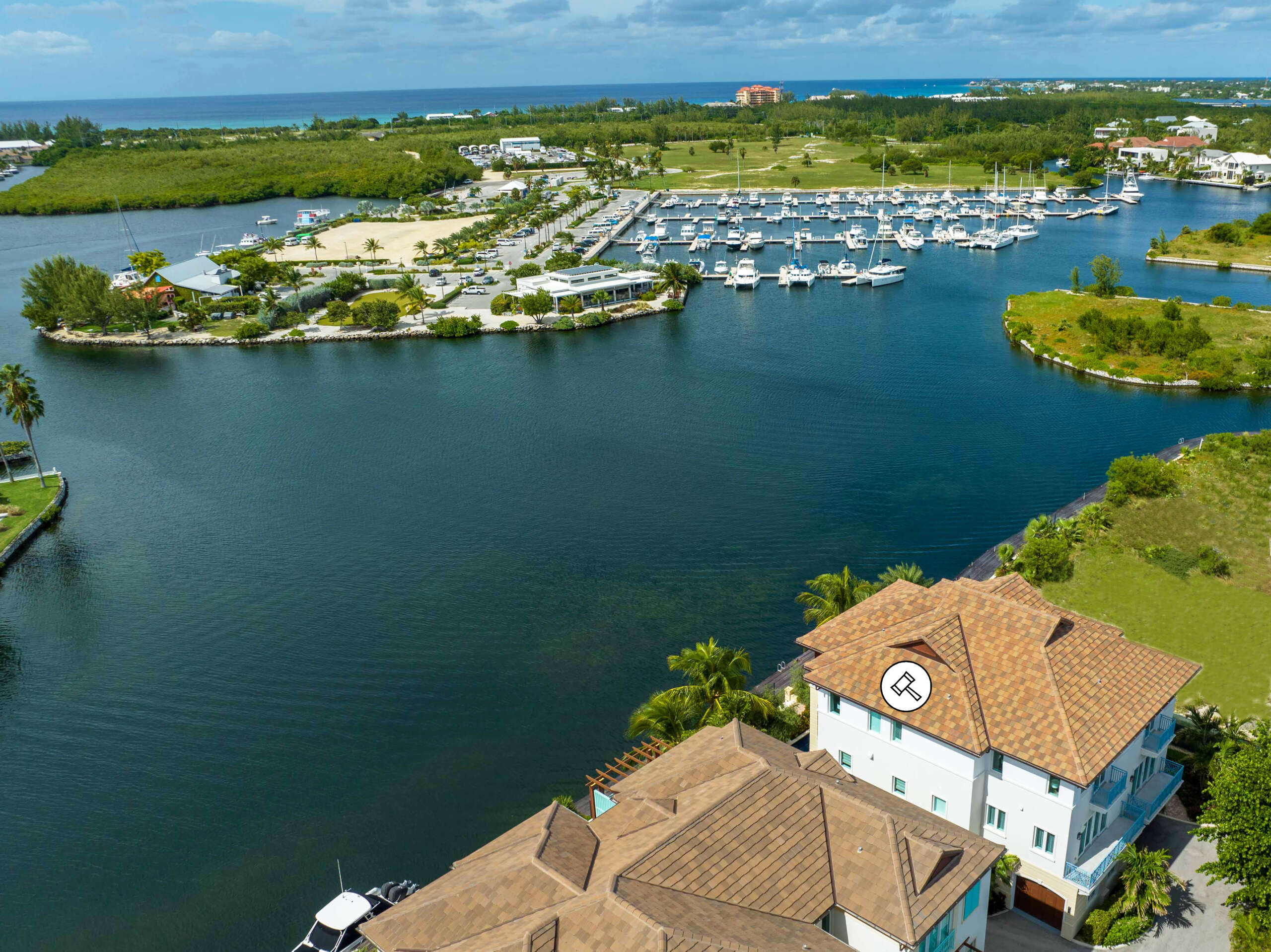The property (marked with a hammer icon) enjoys views over Governors Creek Harbour and the Cayman Islands Yacht Club