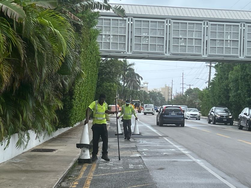 NRA workers remove traffic cones in addition delineators from the sides of West Bay Road. -Photo Courtesy: NRA.