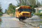 Residents assess water damage as Cayman recovers from deluge A school bus navigates rain-soaked roads to drop off children after classes resumed as usual on Tuesday. - Photos: Dana Kampa