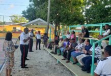 Frustrated residents address safety and housing issues after fatal stabbing Police speak with residents in Windsor Park following the murder of Rodney Rivers. -Photo: Andrel Harris