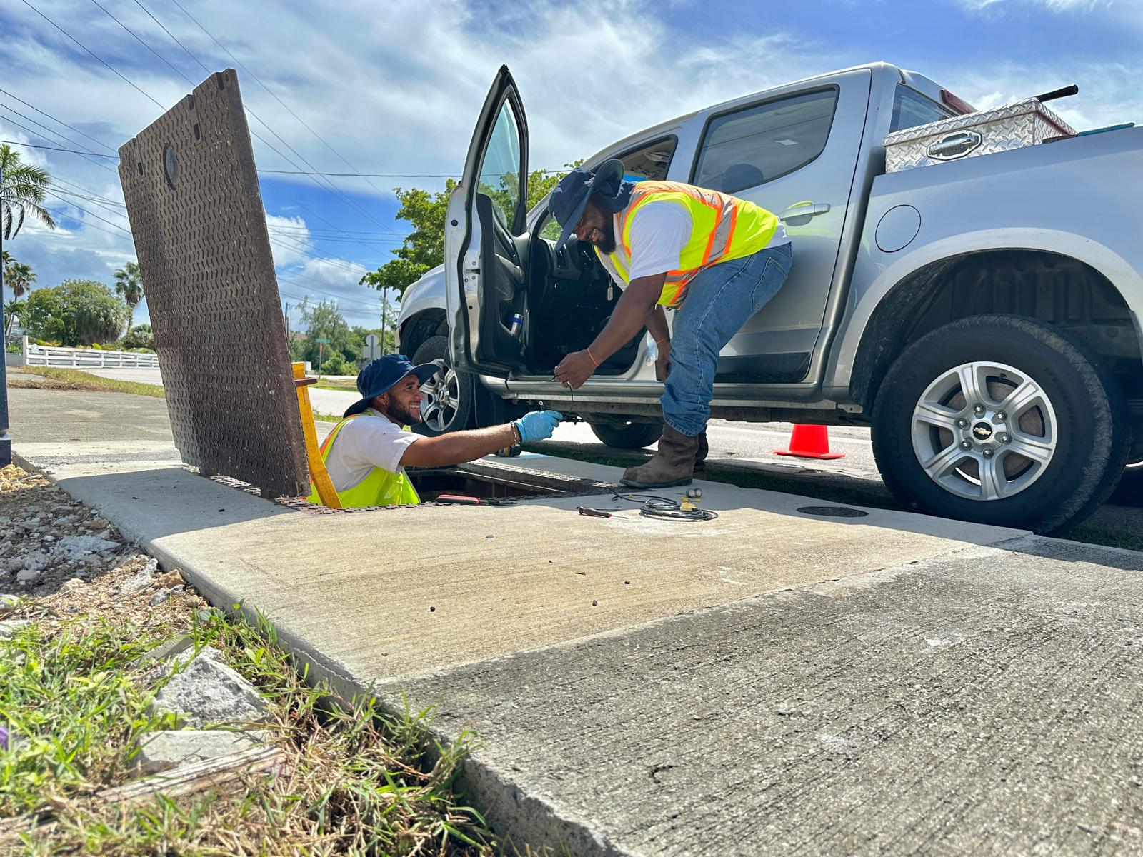 Cayman Water staff check water lines at the top of Sticky Toffee Lane in West Bay on Monday. - Photo: Reshma Ragoonath