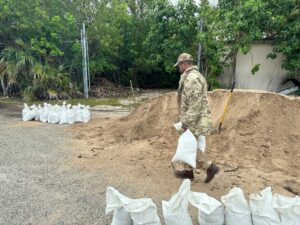 Regiment Lance Corporal Brian Barnes packs bags of sand on Monday for the community to collect. - Photo: Reshma Ragoonath