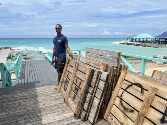 Dive master Lazarus McKenzie shows the wood decking from the dock at Cayman Diving Ltd.