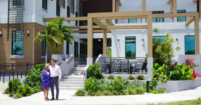 Marla Dukharan and Charlie Kirkconnell sand in front of CEC's new facilities Signal House