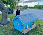 Miniature Cayman cottages return to West Bay roadsides Fiona Jackson celebrates the completion of the miniature cottage restoration project. - Photo: Supplied