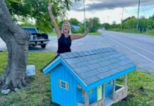 Miniature Cayman cottages return to West Bay roadsides Fiona Jackson celebrates the completion of the miniature cottage restoration project. - Photo: Supplied