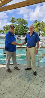 Benny Ebanks and CEO Chris Jackson standing in front of Cayman Turtle Centre&rsquo;s Breeding Pond