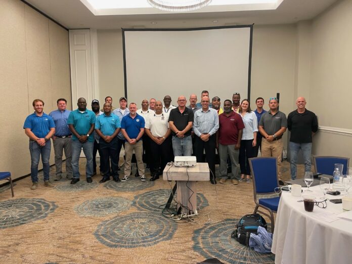 Left to right. Marnus Ehlers (Rubis),Dustin Kersey (Rubis), Ellington Forbes (NRA), James Herbert (NRA), Richard Simms (DEH), Nathan Dack (Regiment), Chris Rivers (NRA), David Broughton (HMCI), Roy Charlton (RCIFS), Brad Hunt (Rubis), D. Randy Rankin (RCIFS), Ian Yearwood (RCIPS), Matthew Simmons (OSRL), Tim Austin (DOE), Andres Barthel (Rubis, front), Martin Vander Touw (DOE, back), Windell Scott (NRA), Sean Haye (NRA), Corey Nelms (NRA), Stacie Sybersma (Ministry of Health), Michael Hernandez (OSRL), Brian Chin Yee (NRA), Gregory Campeau (Rubis). Not pictured: Robert Scotland (CICG), Aliya Dunstan (HMCI).
