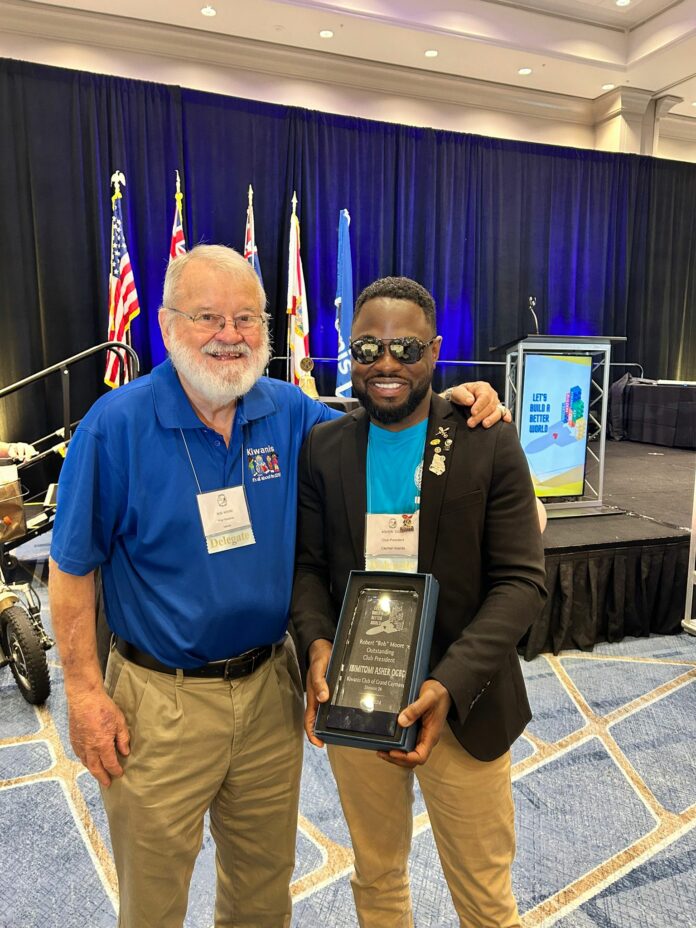 President Ibimitomi Ogbe (right) proudly stands with Robert "Bob" Moore (left), the award's namesake, following Ogbe's historic win of the Robert "Bob" Moore Outstanding Club President Award at the Florida District Convention in Orlando. This moment marks a significant milestone for the Kiwanis Club of Grand Cayman.