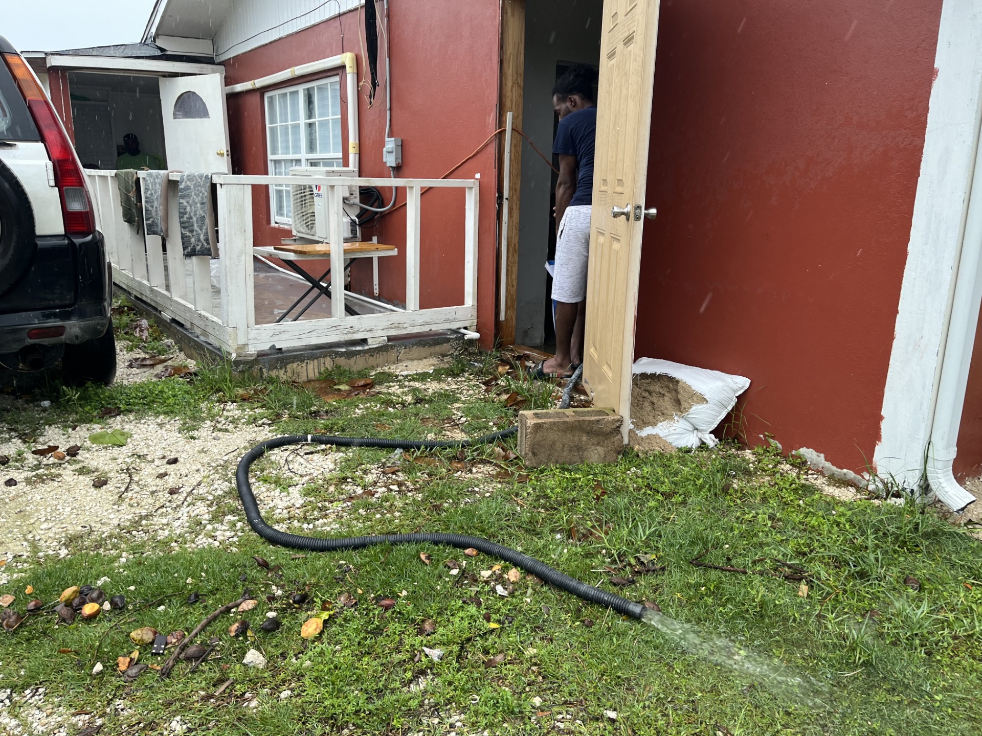 Water is pumped out of a flooded home in Randyke Gardens.