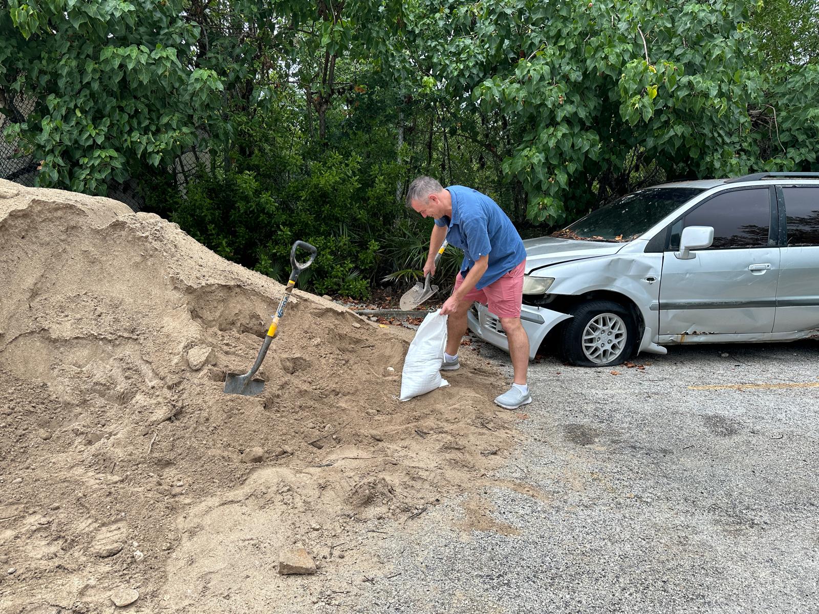 This resident stocks up on sandbags at the West Bay Fire Station on Monday. - Photo: Reshma Ragoonath