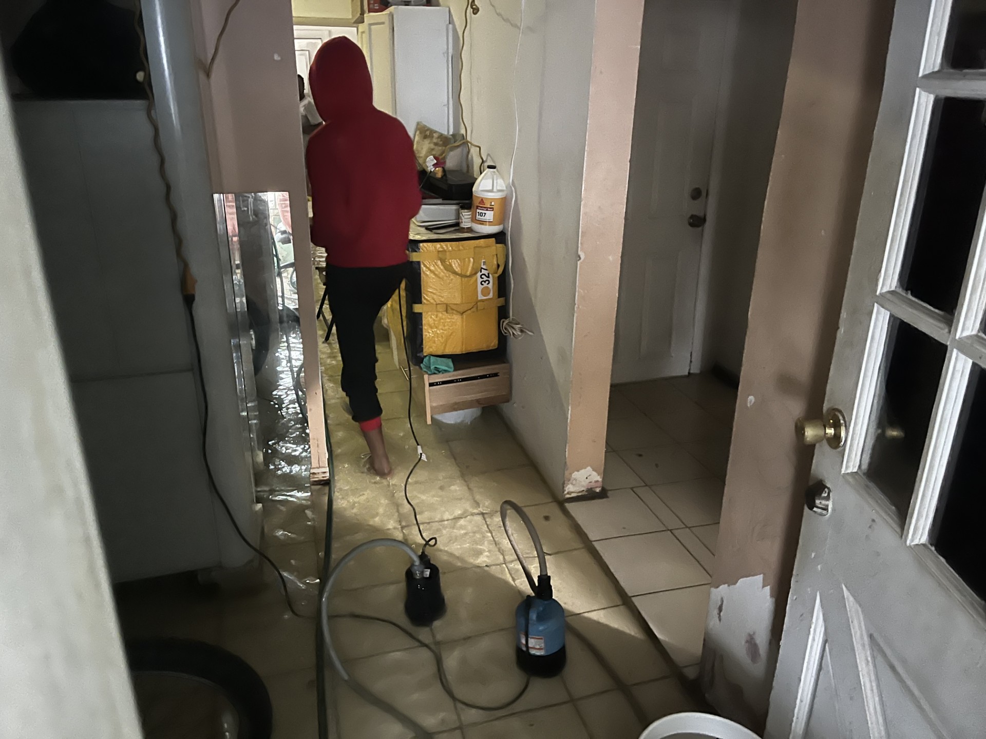 Pumps work to drain floodwaters out of a house on Washington Boulevard. 