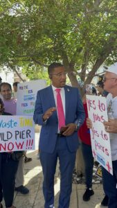 Minister Bryan talking with the crowd gathered outside Parliament