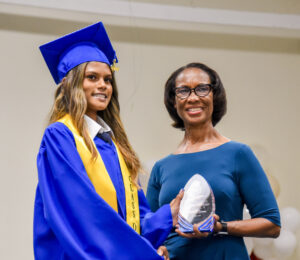Acting Chief Officer for the Ministry of Education Lyneth Monteith presents the Outstanding Prefect Award to Karishma Seeram.