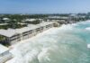 Nothing in government budget to address Seven Mile Beach erosion Beach erosion has meant that waves now crash directly onto the walls of Laguna del Mar on Seven Mile Beach