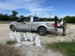 Sandbags at the ready as rain threatens to soak saturated ground truck being loaded with sandbags to prevent flooding from rain