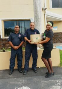 Subway employee delivering sandwiches to members of Cayman Islands Fire Service