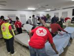 Red Cross staff and volunteers provide shelter during Rafael Red Cross volunteers at a shelter during Rafael