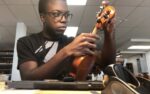 Young musician turns artisan, training as Cayman’s first luthier Zachary Allen is learning the craft of string instrument repair, a service lacking locally. - Photo: Submitted