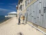 Seven Mile Beach residents begin to bag sand and secure shutters
